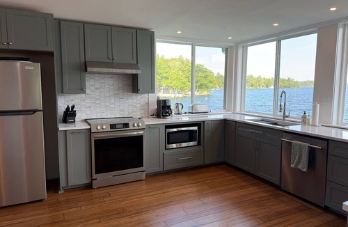 Dedham House | Light-filled lakefront home for up to 15 with private beach and dock near Acadia