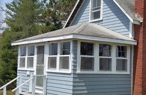 Dennysville Cottage | Rustic, two-story, clapboard cottage, field view, Pet-friendly, Downeast Maine