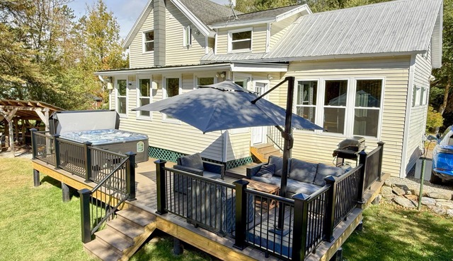 Inviting riverfront home with hot tub on deck & fireplace, near skiing & golf