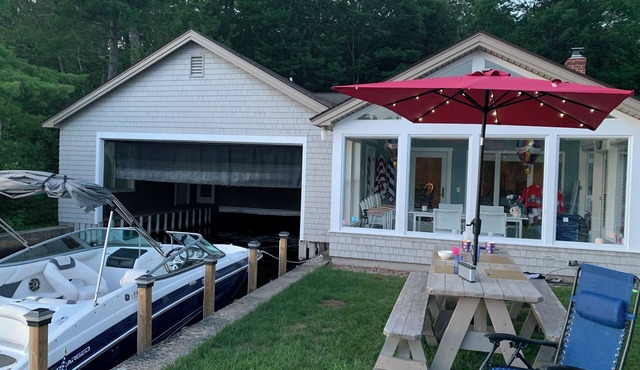 Stunning lakefront home with a boathouse, private dock, firepit and lake views